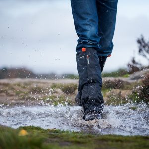 A person walking through a puddle wearing GORE-TEX Gaiters