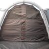 44ZON4E-Zonda-4EP-inside-bedroom-doors-1500x1500-1-1.jpg Interior view of a tent showing a dark grey partition wall with a central vertical strip of five red fabric loops, zipped side panels and a light grey inflatable arch frame above a grey groundsheet.