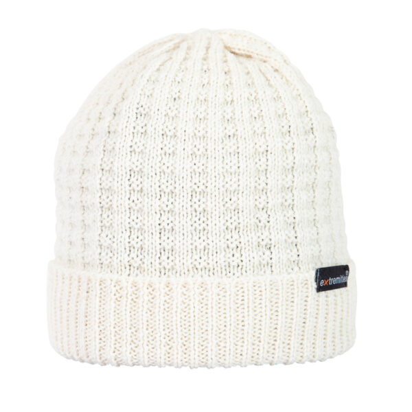Bamford-Beanie-Arran-Cut-Out-300dpi-1.jpg Cream-coloured knitted beanie with a folded ribbed cuff and textured vertical stitch pattern, featuring a small black rectangular brand tag on the cuff.