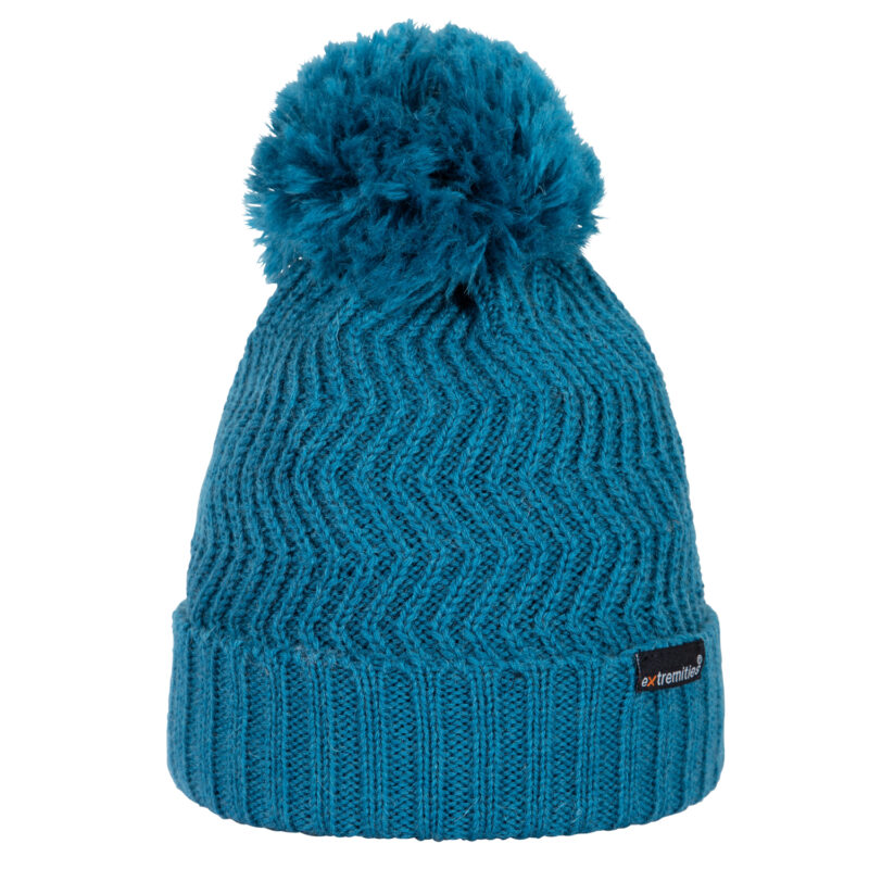 Castleton-Beanie-Kingfisher-Cut-Out-300dpi-1-1.jpg Teal knitted beanie with a ribbed turned-up cuff, chevron knit pattern and a large fluffy pom‑pom on top, plus a small black brand tag on the cuff.
