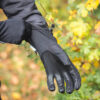Extremitieshoot_Oct2019-157 (1) Black gardening gloves being worn by a person, with colorful foliage in the background, showcasing durability and grip for outdoor tasks.