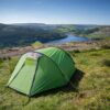 Halcyon-2-3.jpg Bright green dome tent pitched on a grassy hillside overlooking a winding reservoir, wooded valleys and rolling green hills beneath a clear blue sky.
