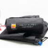 Halny-Elite-1-2-3.jpg Black rolled tent footprint in its storage bag labeled "HALNY ELITE 1 FOOTPRINT" with a yellow‑red Wild Country logo, red drawcord and blue tab, lying on a folded black groundsheet against a white background.