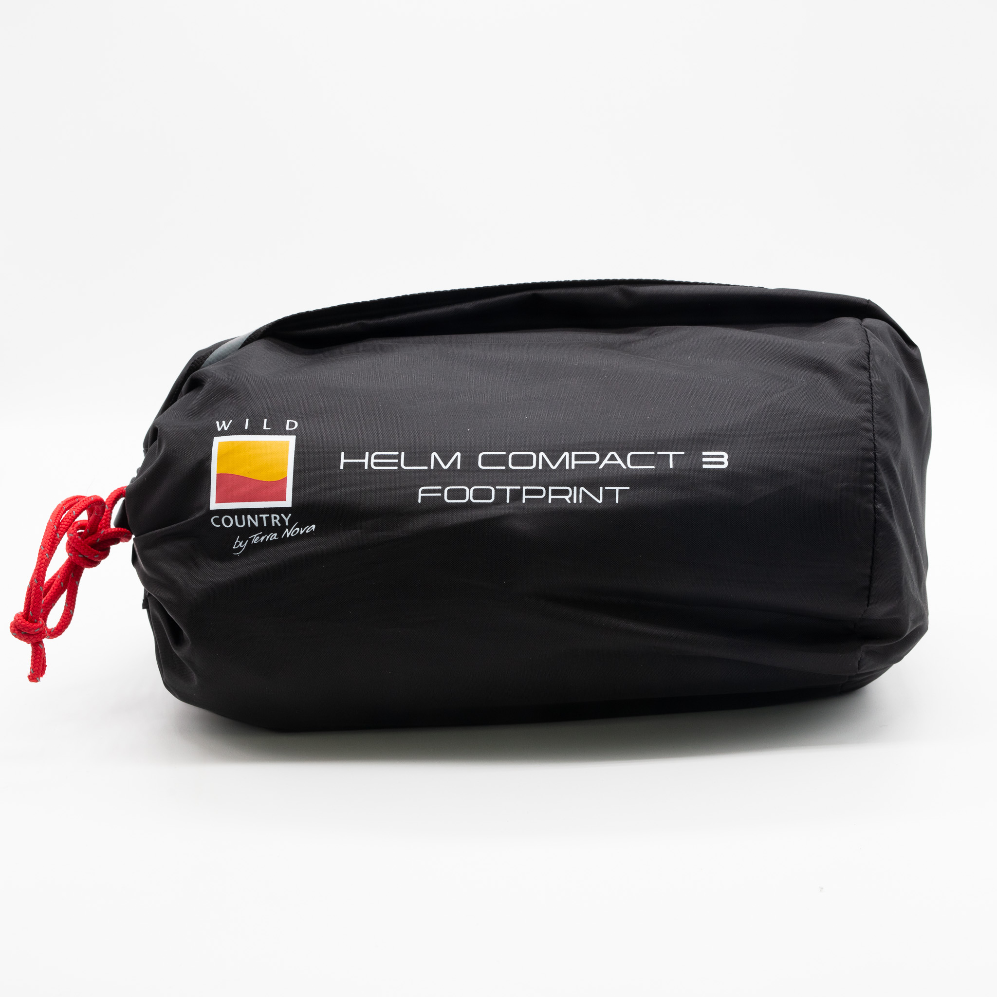 Helm-Compact-3-1-3.jpg Black cylindrical storage bag with a red drawstring, printed white text reading HELM COMPACT 3 FOOTPRINT and a small yellow-and-red Wild Country logo