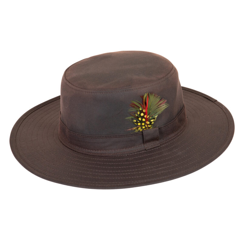 Highclere-Wide-Brim-Hat-Brown-Cut-Out-300dpi-1.jpg Brown wide-brimmed hat with a stitched hatband and a small decorative cluster of green, red and yellow spotted feathers tucked into the band.
