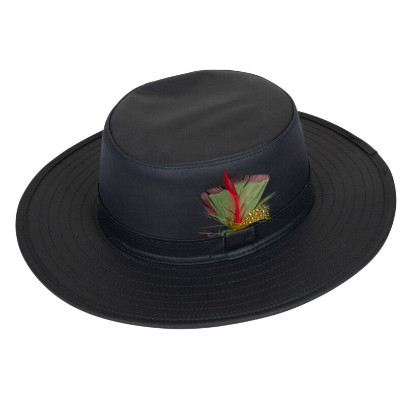 Highclere-Wide-Brim-Hat-Navy-Cut-Out-300dpi-1.jpg Black wide-brimmed hat with a flat crown and stitched brim, featuring a black band and a small side decoration of green and red feathers with a gold-speckled accent.