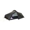 Low-profile black single-wall backpacking tent with taut outer fly and yellow guy lines, partially open front door revealing pale inner mesh and sleeping area.