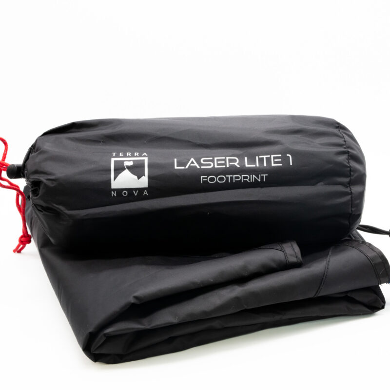 Laser-Lite-1-2-3.jpg Black Terra Nova Laser Lite 1 footprint in a cylindrical stuff sack with red drawcord, labeled with the Terra Nova logo and resting on a folded black groundsheet against a white background.