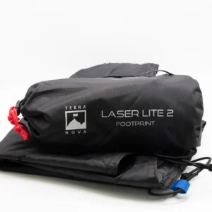 Black rolled storage bag labelled Terra Nova Laser Lite 2 Footprint with a red drawcord, resting on folded black fabric that shows a blue tab and elastic cords