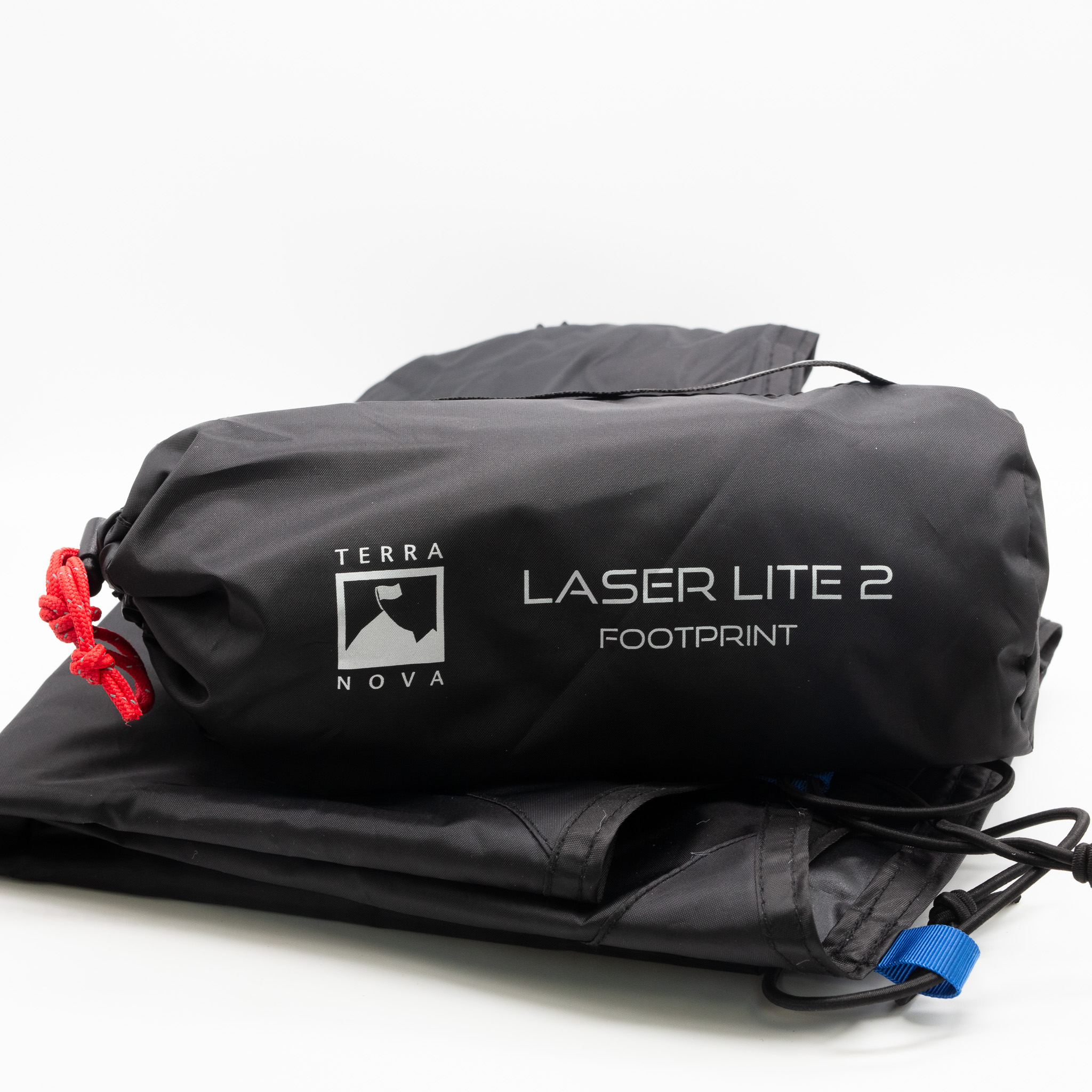Laser-Lite-2-2-7.jpg Packed black fabric stuff sack labelled Terra Nova Laser Lite 2 Footprint with white logo, a red drawcord and a folded black footprint with a blue tab beneath on a white background.