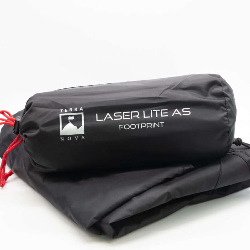 Black Terra Nova Laser Lite A5 footprint rolled in a cylindrical stuff sack with white logo and red drawcord, resting on folded black fabric.