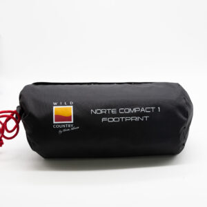 Black cylindrical stuff sack with a red drawcord on a white background, printed with the Wild Country logo and the text “Norte Compact 1 Footprint”.