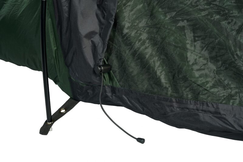 Rockfall-08-03-2121-Terra-Nova-10-04-2021-2962-copy-scaled-4.jpg Close-up of a green and black tent base showing a black support pole through a stitched fabric strap with a metal grommet and a loose drawcord ending in a plastic toggle.
