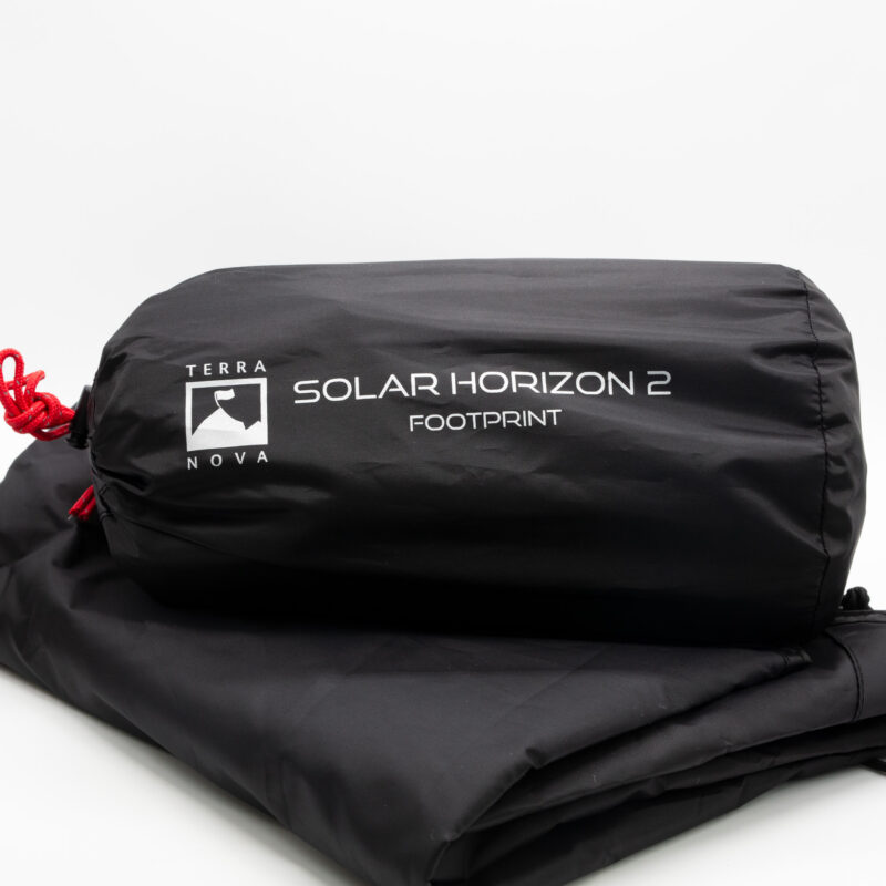 Solar-Horizon-2-3-3.jpg Black cylindrical stuff sack with a white mountain-flag logo and the text 'TERRA NOVA SOLAR HORIZON 2 FOOTPRINT', featuring a red drawcord and resting on folded black fabric against a white background.