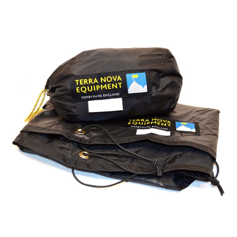 Terra-Nova-Footprint-Bag-1500x1500-72dpi-3.jpg Black Terra Nova Equipment stuff sack with yellow logo patch and small mountain icon sitting on a folded black waterproof sheet showing brass grommets and a knotted drawcord