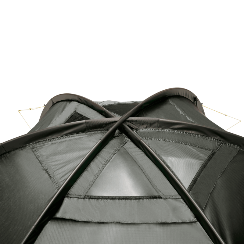 Close-up of the top of a dark green camping tent showing two black flexible poles crossing in an X over triangular mesh ventilation panels and stitched seams, with thin guy lines extending from the upper corners.