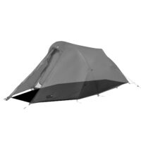 Two-person dome-style backpacking tent with a covered front vestibule propped open, light grey flysheet over a dark bathtub floor, arched poles and guy lines staked out to the ground.