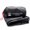 Voyager-Lite-2-3.jpg Folded black Terra Nova Voyager Lite footprint with its cylindrical stuff sack showing the white logo and text 'VOYAGER LITE FOOTPRINT' and a red drawcord at one end.