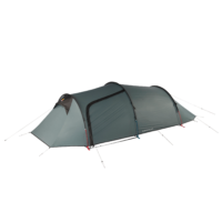 Green-grey, low-profile three-person tunnel tent with arched poles, a front vestibule and a zippered side door, secured with red and blue guy lines on a plain background.