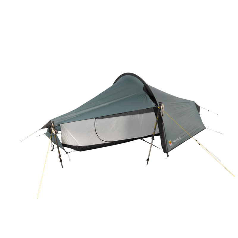 WC-Halny-Elite-1-CO2-3.webp Low-profile single-person tunnel tent with a teal-grey rainfly and light-grey mesh inner, propped up by trekking poles and yellow guy lines, showing a black bathtub floor and a D-shaped side door.