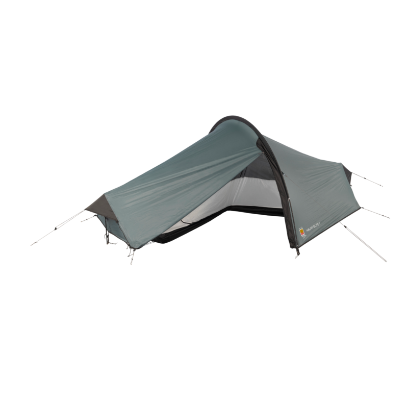 WC-Halny-Elite-1-CO5-3.webp Low-profile grey-green tunnel tent pitched with a curved pole and taut rainfly, partially open to reveal an inner mesh door and black bathtub-style floor, with guy lines staked out.