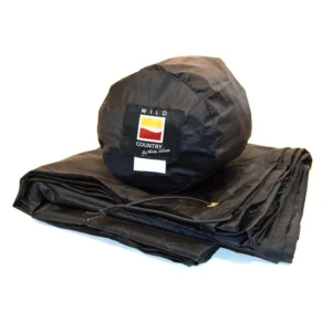 Folded black waterproof groundsheet with a matching cylindrical stuff sack displaying a square 'WILD COUNTRY by Terra Nova' logo patch.