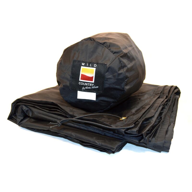 Folded black waterproof groundsheet with a matching cylindrical stuff sack displaying a square 'WILD COUNTRY by Terra Nova' logo patch.