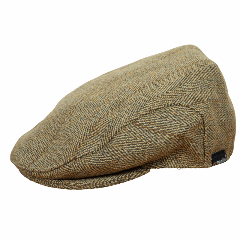 Woburn-Flat-Cap-Light-Tweed_1500px_300dpi-1.png Greenish-brown herringbone tweed flat cap with a short rounded brim, visible top seam and a small black brand tag on the side.