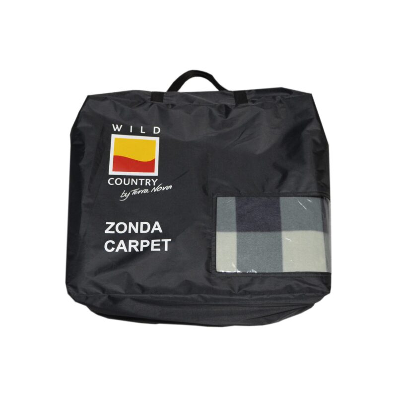 Black carry bag with a top handle printed 'WILD COUNTRY by Terra Nova' and 'ZONDA CARPET', showing a grey-and-blue check carpet through a clear window.