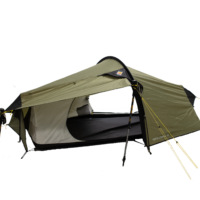 Olive-green tunnel tent with a curved front awning, open entrance showing a white inner lining and black groundsheet, supported by black poles and tensioned yellow guy lines.