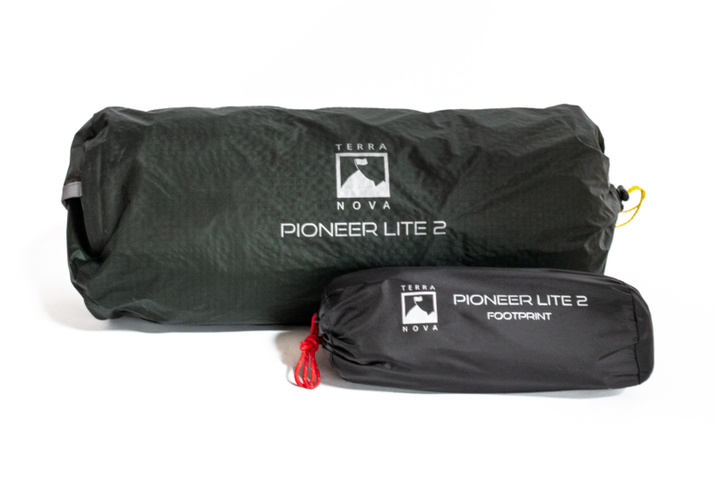 pioneer_lie_footprint__1-3.webp Dark green rolled tent bag labeled Terra Nova Pioneer Lite 2 alongside a smaller black stuff sack marked Pioneer Lite 2 Footprint with a red cord pull.