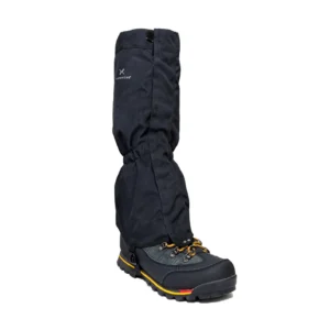 revised-fieldgaiter-black-white-background-3.jpg Black waterproof gaiter pulled over a black hiking boot with yellow laces and a yellow-and-red striped rugged sole, elasticated at the ankle and bearing a small 'Extremities' logo.