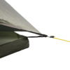 solar_photon_2_co__5__airocorner-1.webp Close-up of a green ripstop tent fly corner showing overlapping inner fabric, a black webbing attachment clipped into a small plastic cord tensioner and a yellow guyline tied in a knot against a white background