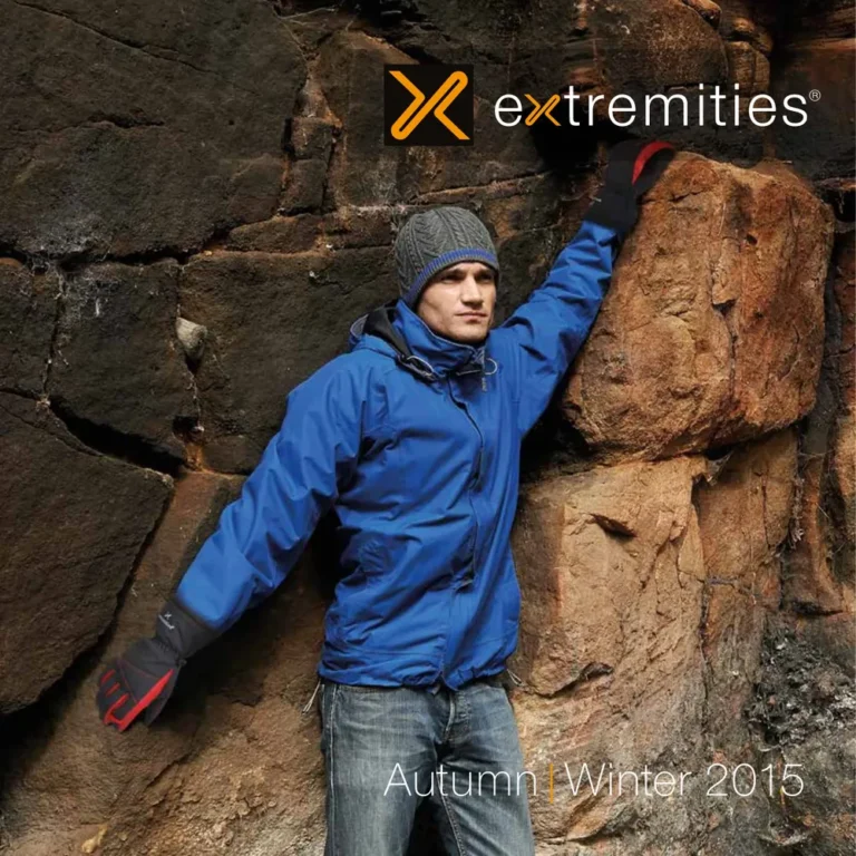 Man wearing a blue jacket and gray beanie, climbing on rocky terrain, showcasing outdoor apparel from Extremities, Autumn/Winter 2015 collection.