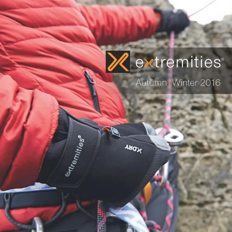 Climber wearing black gloves and a red jacket while ascending a rocky surface, demonstrating the use of climbing gear and safety equipment in an outdoor adventure setting.