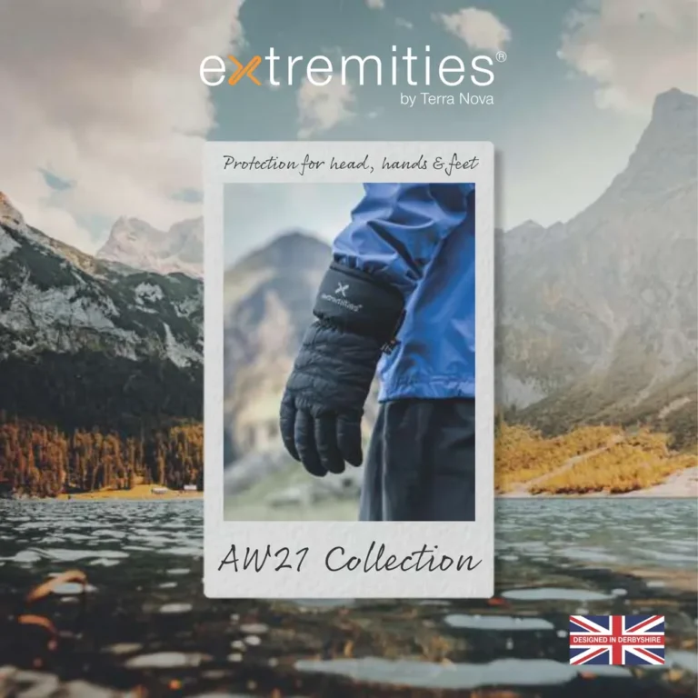 Image showcasing the AM21 Collection by Extremities, featuring a close-up of a person wearing insulated gloves against a scenic mountain backdrop. Ideal for outdoor activities in cold weather.